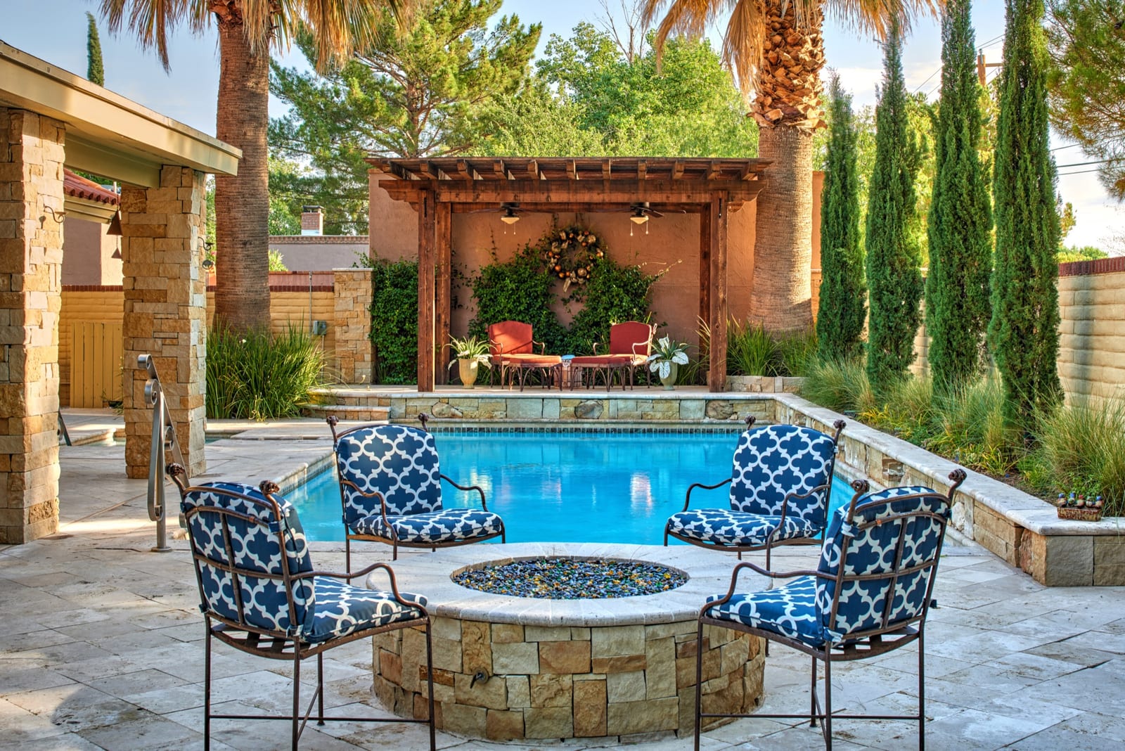 A pool and circular fire feature arranged as an intimate outdoor room.